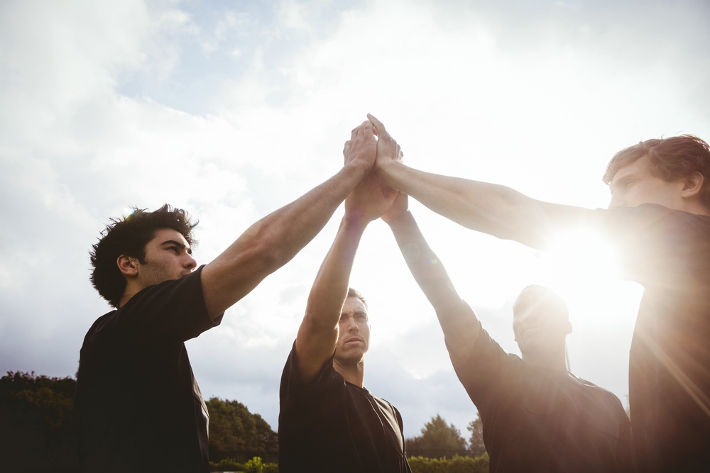 co-ordinated Rugby players standing together before match at the park